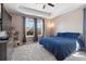 Cozy primary bedroom features a ceiling fan, TV and a window offering great natural light at 4834 S Wenatchee St, Aurora, CO 80015