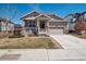 Charming home with well-manicured lawn, covered porch, and attached two-car garage at 4834 S Wenatchee St, Aurora, CO 80015