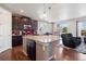 Modern kitchen boasts granite countertops, stainless steel appliances and large island seating at 4834 S Wenatchee St, Aurora, CO 80015