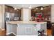 Spacious kitchen featuring granite counters, stainless steel appliances, and dark wood cabinetry at 4834 S Wenatchee St, Aurora, CO 80015