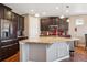 Well-appointed kitchen featuring stainless steel appliances, granite countertops, and dark wood cabinets at 4834 S Wenatchee St, Aurora, CO 80015