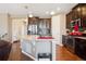 Gourmet kitchen featuring a large island, stainless steel appliances, and dark wood cabinetry at 4834 S Wenatchee St, Aurora, CO 80015