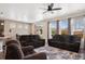 Bright living room featuring dark furniture, large windows, and an open floor plan at 4834 S Wenatchee St, Aurora, CO 80015