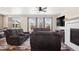 Spacious living room with fireplace, a ceiling fan, and a wall-mounted television for entertainment at 4834 S Wenatchee St, Aurora, CO 80015