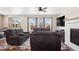 Comfortable living room with a ceiling fan, fireplace, and large windows for ample natural light at 4834 S Wenatchee St, Aurora, CO 80015