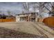 Large backyard with wooden fence, grass, and two-story home at 12866 E Ohio Ave, Aurora, CO 80012
