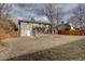 Large backyard with wooden fence and view of the back of the house at 12866 E Ohio Ave, Aurora, CO 80012