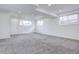 Finished basement with grey carpet and multiple windows at 12866 E Ohio Ave, Aurora, CO 80012