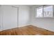 Bright bedroom featuring hardwood floors and double closets at 12866 E Ohio Ave, Aurora, CO 80012