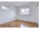 Simple bedroom with hardwood floors and large window at 12866 E Ohio Ave, Aurora, CO 80012