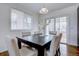 Bright dining room with dark wood table and access to backyard at 12866 E Ohio Ave, Aurora, CO 80012