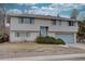Tan brick ranch home with attached garage and landscaping at 12866 E Ohio Ave, Aurora, CO 80012