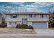 Tan brick ranch home with attached garage and landscaping at 12866 E Ohio Ave, Aurora, CO 80012