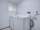 Laundry room with washer and dryer, window with blinds, and white walls at 12866 E Ohio Ave, Aurora, CO 80012