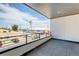 Spacious balcony with a view of the neighborhood under a bright blue, partly cloudy sky at 2400 S Delaware St # 1, Denver, CO 80223