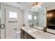 Bright bathroom featuring double sink vanity, modern fixtures and glass enclosed walk-in shower at 2400 S Delaware St # 1, Denver, CO 80223