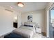 Bright bedroom with ensuite, large windows leading to a balcony, neutral tones, and modern decor for a calming retreat at 2400 S Delaware St # 1, Denver, CO 80223