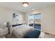 Inviting bedroom with a plush bed, modern artwork, and access to a private balcony offering city views for relaxation at 2400 S Delaware St # 1, Denver, CO 80223