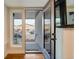 Condo entrance with glass door, transom window and exterior view at 2400 S Delaware St # 1, Denver, CO 80223