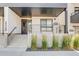 Modern condo entrance with white concrete steps, black railings, and address numbers at 2400 S Delaware St # 1, Denver, CO 80223