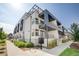 Modern condo building with balconies, clean lines and contemporary design under a bright sky at 2400 S Delaware St # 1, Denver, CO 80223