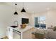 Modern kitchen with stainless steel appliances, marble countertops, and access to the balcony, creating a seamless indoor-outdoor flow at 2400 S Delaware St # 1, Denver, CO 80223