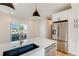 Bright kitchen featuring stainless steel appliances, modern cabinetry and countertop, and a view to an outdoor balcony at 2400 S Delaware St # 1, Denver, CO 80223