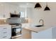 Modern kitchen showcasing stainless steel appliances, quartz countertops, and a stylish backsplash at 2400 S Delaware St # 1, Denver, CO 80223
