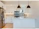Contemporary kitchen featuring stainless steel appliances, quartz countertops, and white cabinets at 2400 S Delaware St # 1, Denver, CO 80223