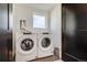 Bright laundry room with a modern washer and dryer set, plus a window at 2400 S Delaware St # 1, Denver, CO 80223