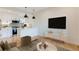 Cozy living room with a modern island kitchen, stainless steel appliances and a flatscreen TV for a relaxed entertainment space at 2400 S Delaware St # 1, Denver, CO 80223
