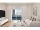 Bright living room featuring contemporary decor, large sliding doors to the balcony, and a stylish seating arrangement at 2400 S Delaware St # 1, Denver, CO 80223