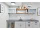 Finished basement bar area featuring a sleek design, ample storage, and a convenient wine refrigerator at 5984 Fulton St, Denver, CO 80238
