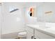 Modern bathroom features white subway tile, a sleek vanity, and contemporary fixtures at 5984 Fulton St, Denver, CO 80238