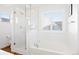 Bright bathroom showcases a soaking tub and glass-enclosed shower, accented by subway tile at 5984 Fulton St, Denver, CO 80238