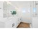Bright bathroom features dual sinks with white countertops and modern black hardware and walk-in shower at 5984 Fulton St, Denver, CO 80238