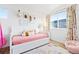 Bright bedroom features a colorful area rug and cheerful decor, creating a cozy atmosphere at 5984 Fulton St, Denver, CO 80238