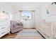 Cozy Bedroom boasts a neutral color palette with cute decor, ideal for a soothing environment at 5984 Fulton St, Denver, CO 80238
