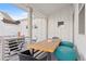 Cozy covered patio with comfortable seating, a dining table, and serene views, ideal for outdoor enjoyment at 5984 Fulton St, Denver, CO 80238