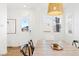 Bright dining area features hardwood floors, a wooden table, and a stylish wicker pendant light at 5984 Fulton St, Denver, CO 80238