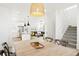 Open concept dining room shows stairs, kitchen and living room with natural light at 5984 Fulton St, Denver, CO 80238