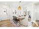 Bright dining area features a wooden table and a stylish wicker pendant light at 5984 Fulton St, Denver, CO 80238