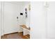 Bright entryway with white walls, wood floors, a built-in bench, and decorative accents at 5984 Fulton St, Denver, CO 80238