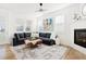 Bright living room features a cozy fireplace, comfortable sectional sofa, and stylish decor at 5984 Fulton St, Denver, CO 80238