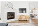 Living room with fireplace, TV, cabinet and dining room in the background at 5984 Fulton St, Denver, CO 80238