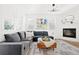 Cozy living room with a fireplace, large sofa, ottoman and ample natural light at 5984 Fulton St, Denver, CO 80238