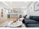 Basement living room with wet bar provides extra living space with modern décor and fixtures at 5984 Fulton St, Denver, CO 80238