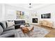 Bright living room features a cozy fireplace, comfortable sectional sofa, and stylish decor at 5984 Fulton St, Denver, CO 80238