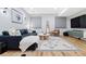 Cozy living room features a comfortable sectional sofa and stylish decor and wood flooring at 5984 Fulton St, Denver, CO 80238
