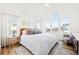 Bright main bedroom with vaulted ceilings, large windows, and a cozy sitting area at 5984 Fulton St, Denver, CO 80238